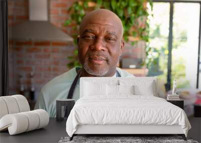 Portrait of serious african american senior man in kitchen Wall mural