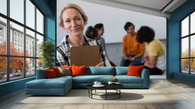 Portrait of teacher with students in background Wall mural