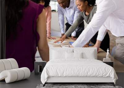 Vertical image of diverse female and male businesspeople talking and working Wall mural