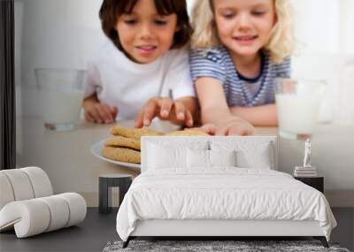 Adorable siblings eating biscuits Wall mural