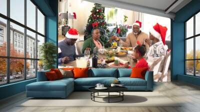 African american family spending time together and praying before having christmas meal Wall mural