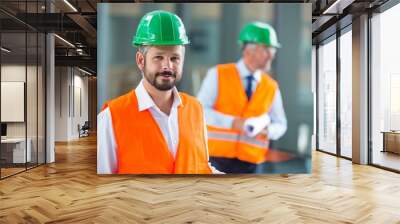 Architect in hard hat standing in office corridor Wall mural