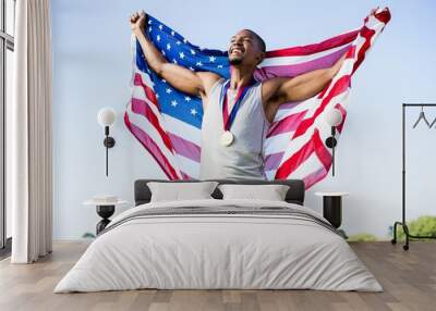 Athlete posing with American flag  Wall mural