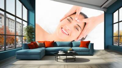 Attractive woman receiving head massage at spa center Wall mural