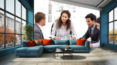 Beautiful manager speaking with her team during a meeting Wall mural