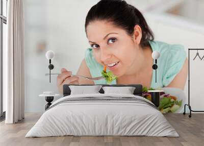 Beautiful woman eating salad Wall mural