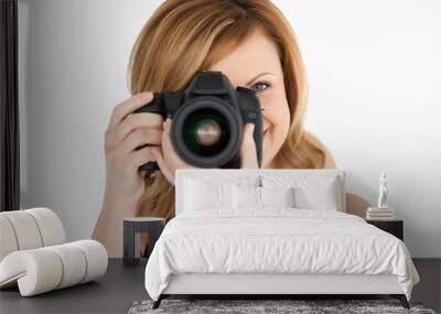 Blond-haired woman taking a photo with a camera Wall mural