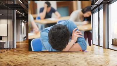 Boy sleeping at desk Wall mural