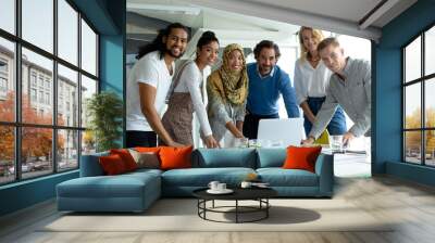 Business people looking at camera while working together at conference room in a modern office Wall mural