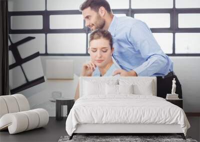 Businessman harassing female colleague at computer desk Wall mural