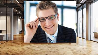 Businessman looking to the camera wearing glasses Wall mural