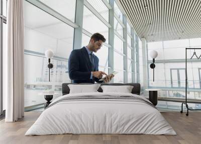 Businessman using tablet computer at work Wall mural