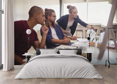 Businesswoman explaining to male colleagues at creative office Wall mural