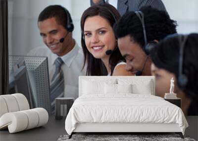 Businesswoman in a call center with her team and manager Wall mural