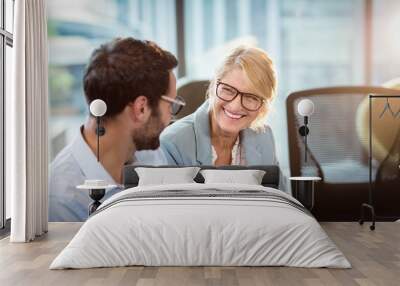 Businesswoman interacting with a colleague Wall mural