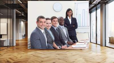 Businesswoman reporting to sales figures to her colleagues Wall mural