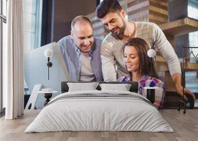 Businesswoman showing documents to male coworkers Wall mural