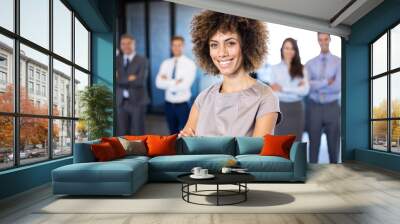 businesswoman smiling while her colleagues standing Wall mural