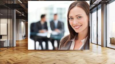 cheerful businesswoman during a meeting with her two male collea Wall mural