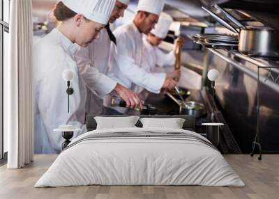 chef frying fish in a frying pan Wall mural