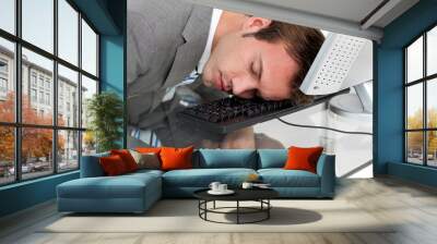 Close-ep of a tired businessman sleeping on his desk Wall mural