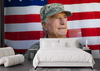 Close-up of caucasian army soldier wearing camouflage clothing looking away against flag of america Wall mural