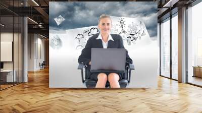 Composite image of businesswoman sitting on swivel chair with la Wall mural