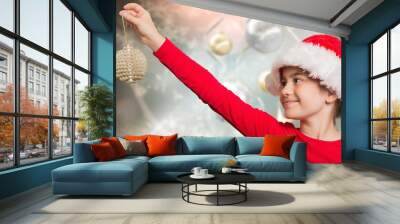 Composite image of festive girl hanging decoration Wall mural