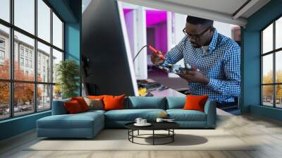 Computer african american engineer repairing motherboard at desk Wall mural