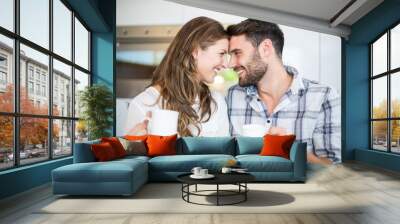 Couple with coffee mug looking at each other Wall mural