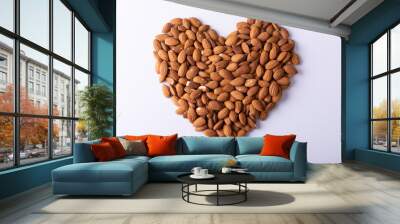 Directly above shot of almonds arranged in heart shape pattern on wooden white background Wall mural