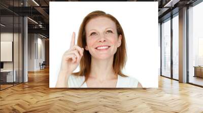 Enthusiastic businesswoman pointing at a copyspace Wall mural