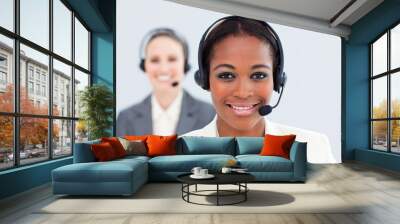 ethnic businesswoman and her colleague with headset on Wall mural