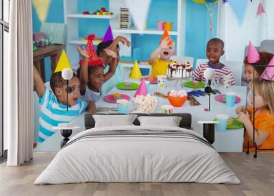 Excited kids enjoying a birthday party Wall mural