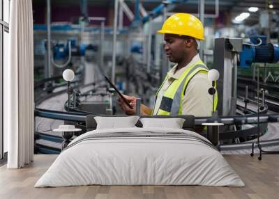 Factory worker using a digital tablet near the production line Wall mural