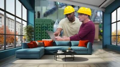 Factory workers discussing and working on laptop  Wall mural