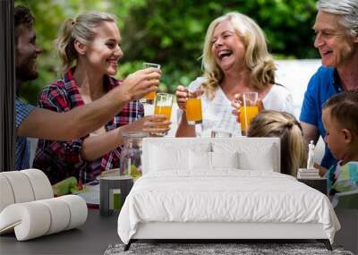 family toasting drinks while having lunch at lawn Wall mural