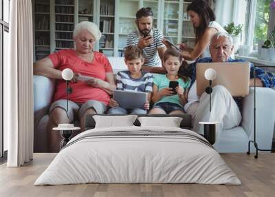 family using laptop, mobile phone and digital t Wall mural