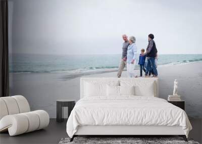 Family walking together on the beach Wall mural