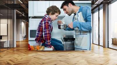 Father and son cooking food together Wall mural