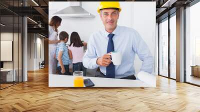 father wearing hardhat and drinking coffee at home with his fami Wall mural