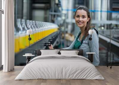 Female factory worker standing near production line Wall mural