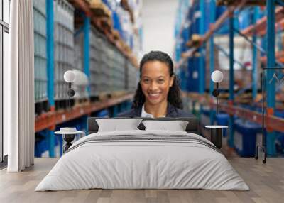 female manager holding clipboard in warehouse Wall mural