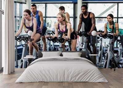 Fit people working out at spinning class Wall mural