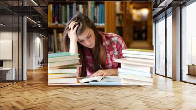 Focused student surrounded by books Wall mural