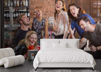 Friends playing beer pong on table Wall mural