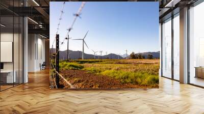 General view of wind turbines in countryside landscape with cloudless sky Wall mural