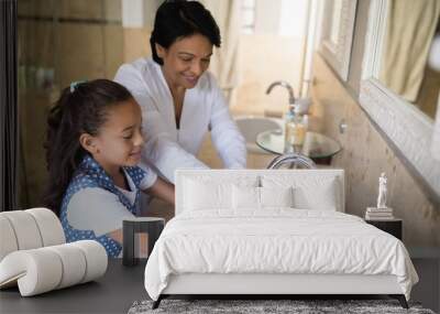 Grandmother and granddaughter washing hands at bathroom sink Wall mural