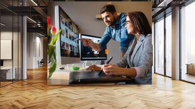 Graphic designer pointing at monitor Wall mural