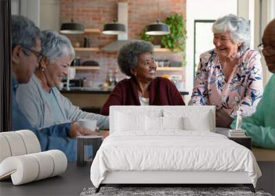 Group of diverse senior male and female friends doing puzzles at home Wall mural